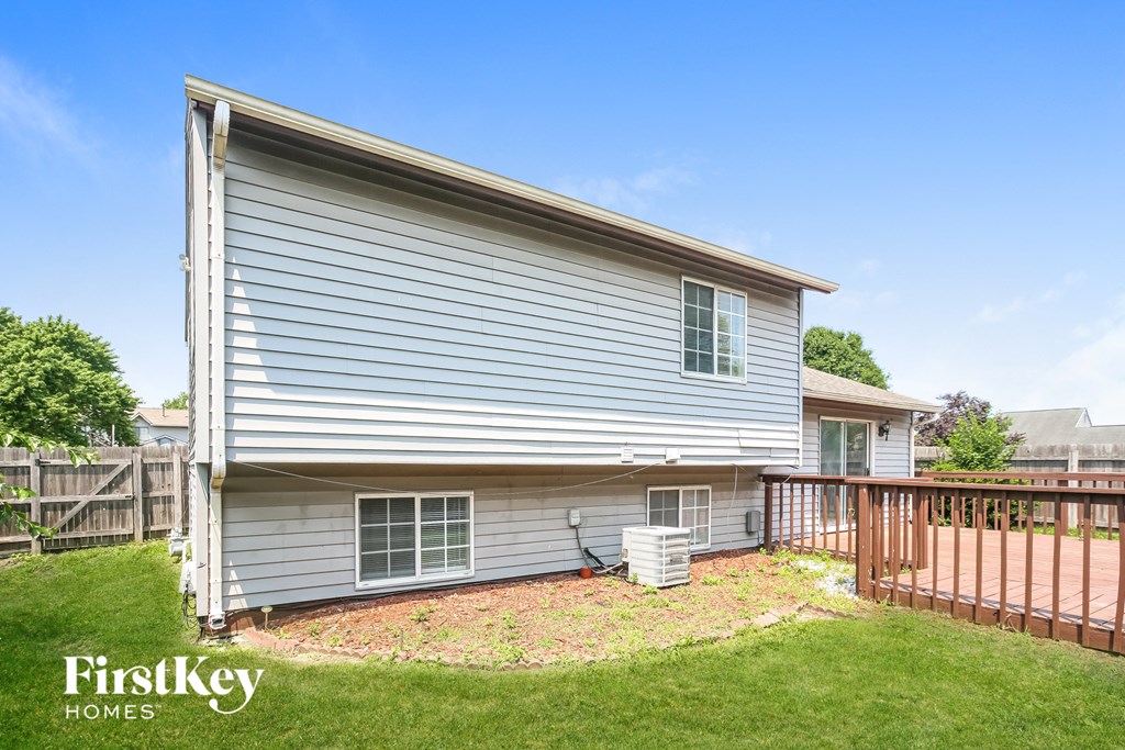 the backyard of a house with a yard and a fence