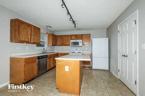 a kitchen with wooden cabinets and a white counter top