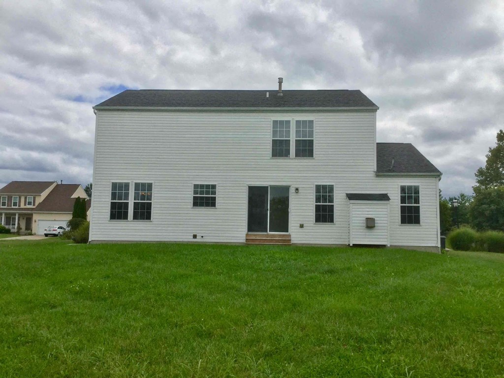 a white house with a lawn in front of it