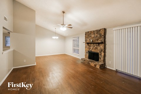 a living room with a fireplace and a wooden floor