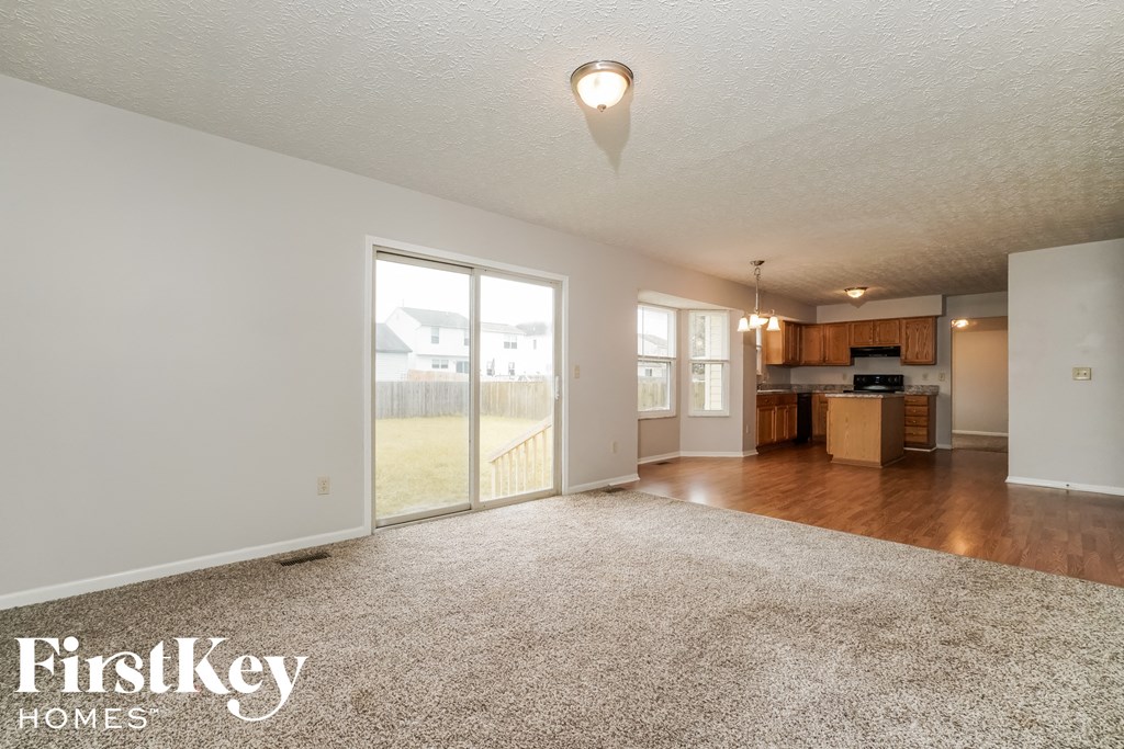 the living room and kitchen of an open floor plan