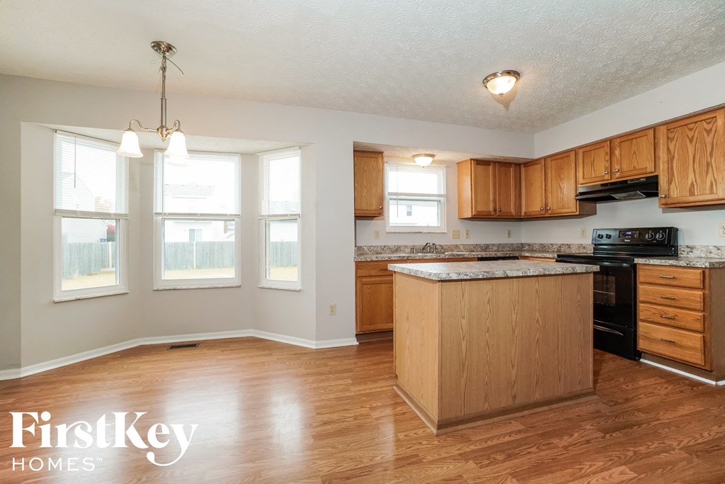 an empty kitchen with wooden cabinets and a counter top