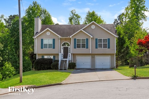 A two-story house with a garage is for sale.