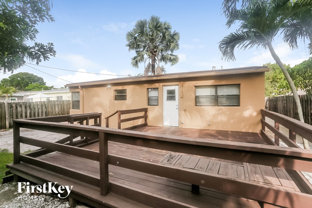 a small house with a deck and a porch