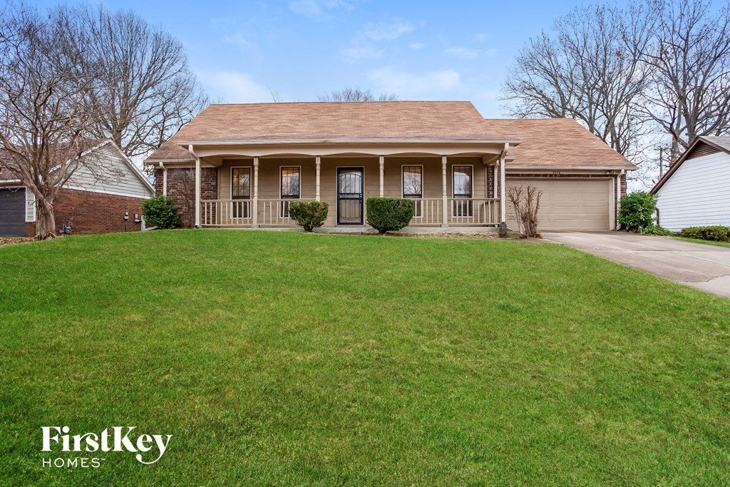 A house with a lawn in front of it.