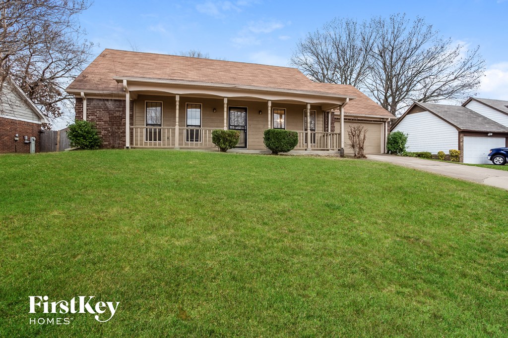 A house with a lawn in front of it.