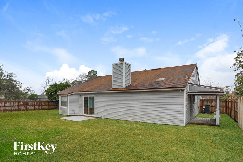 a small white house with a yard and a backyard