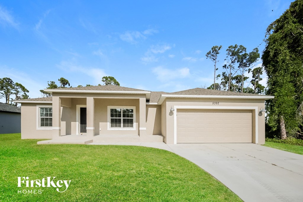 A house with a garage and a driveway is for sale.