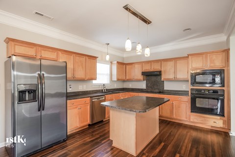 a kitchen with wooden cabinets and stainless steel appliances