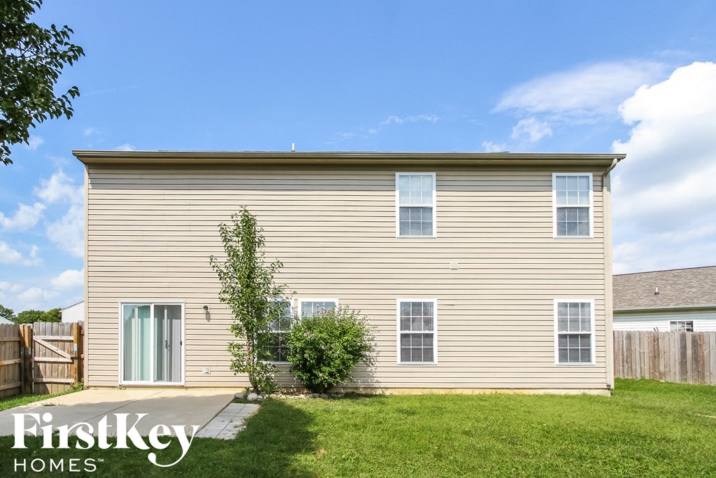 a small house with a yard and a sidewalk