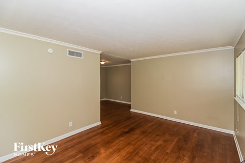 a living room with wood floors and beige walls and a white ceiling