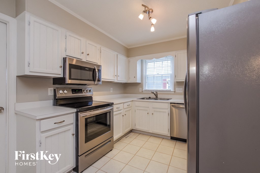 A kitchen with a refrigerator on the right.