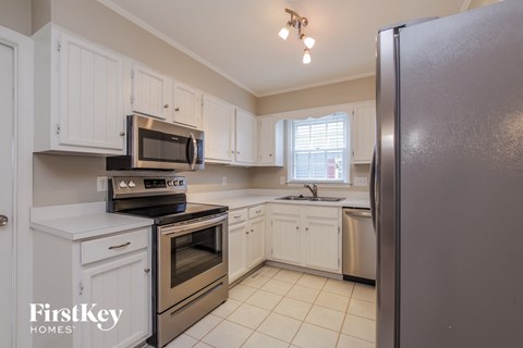 A kitchen with a refrigerator on the right.