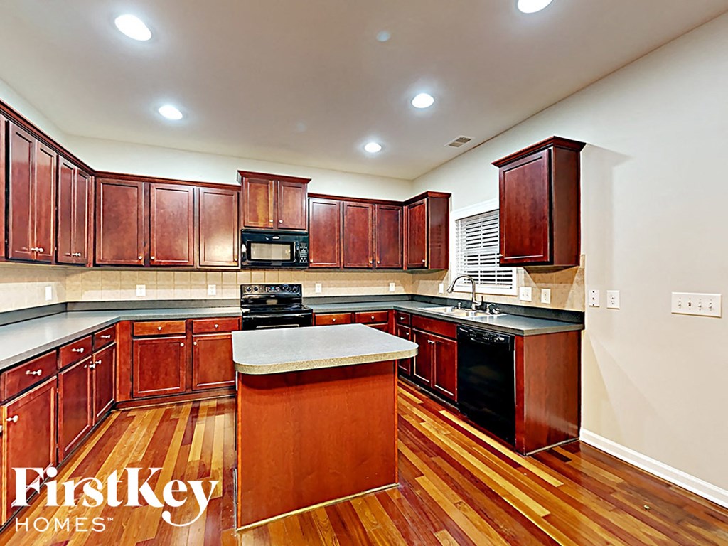 A kitchen with wooden cabinets and a center island.