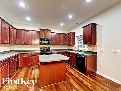 A kitchen with wooden cabinets and a center island.