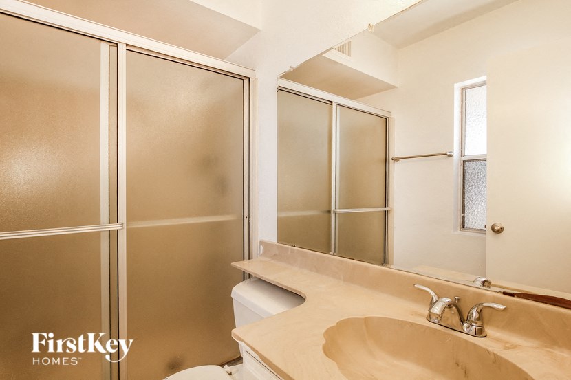 a bathroom with a sink and a mirror and a shower