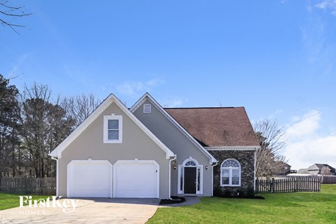 the front of a house with a white garage door