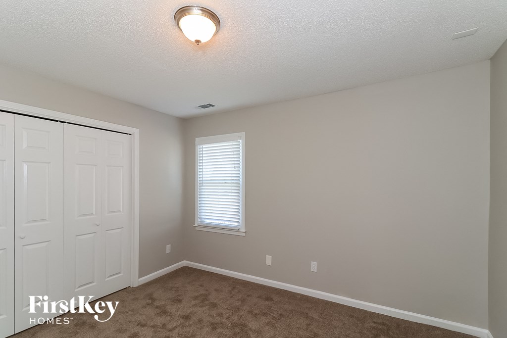 a bedroom with a closet and a white door