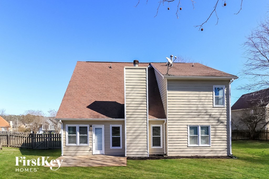 a small house with a roof and a bird on top of it