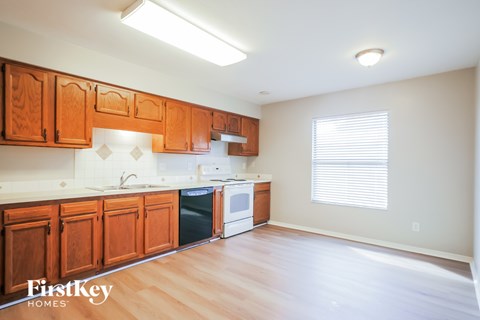 A kitchen with wooden cabinets and a dishwasher.