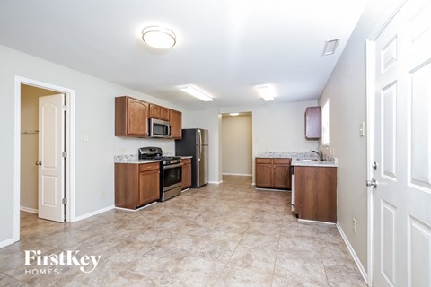 a kitchen with wooden cabinets and stainless steel appliances