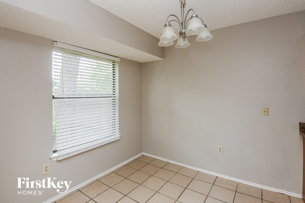 the living room of an empty house with a large window