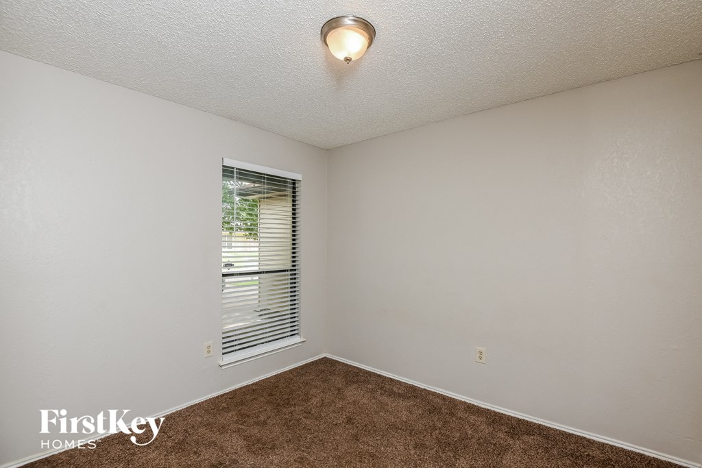 the living room of a small white house with a window