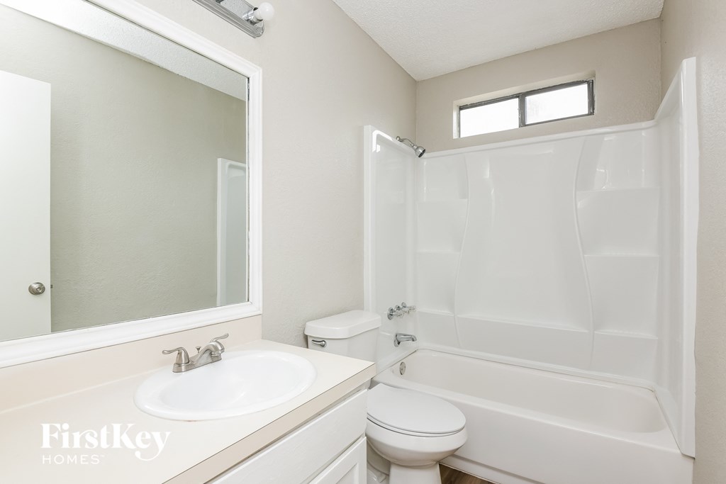 a bathroom with a sink toilet and a tub