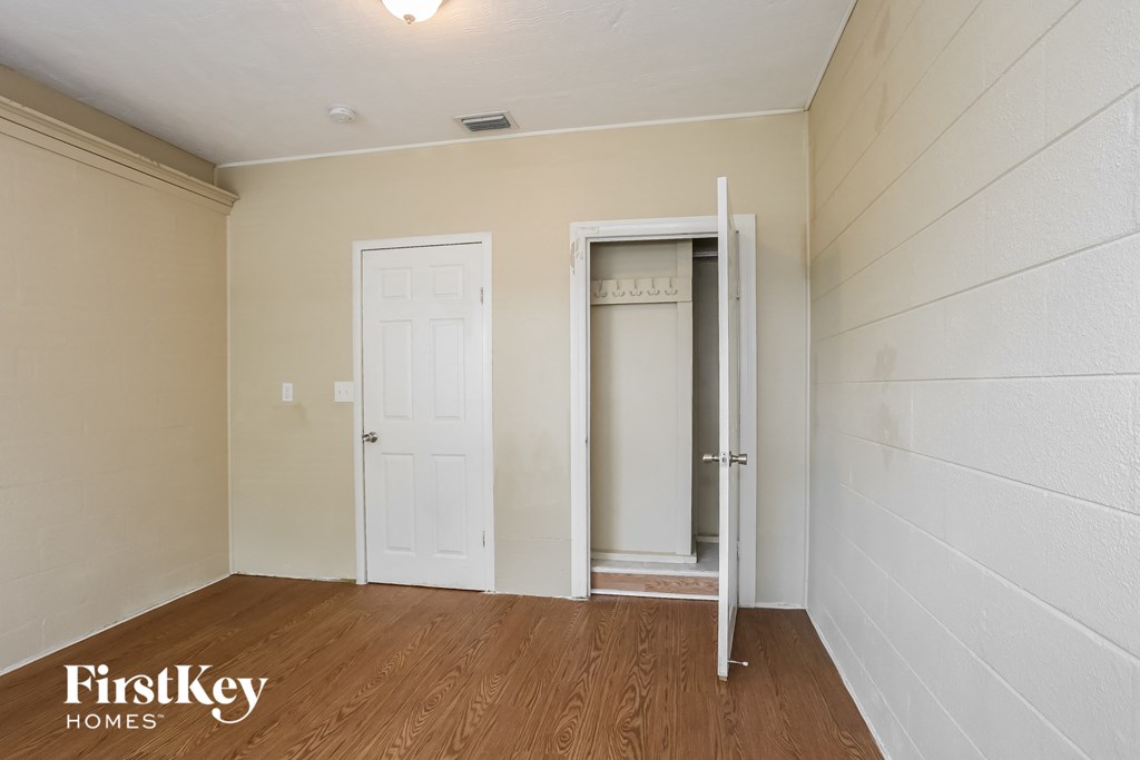 A room with a white door and a white wall.