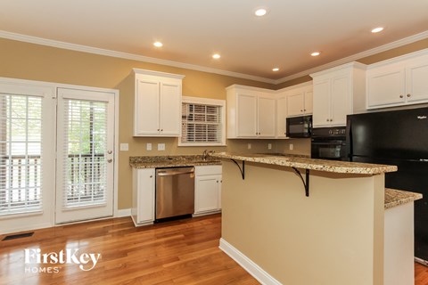 a kitchen with white cabinets and a counter top