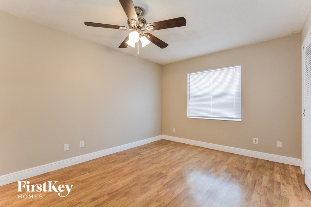 a living room with hardwood floors and a ceiling fan