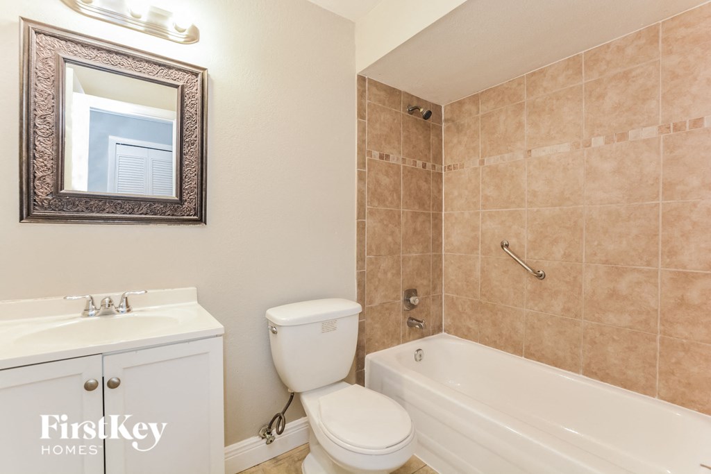 a bathroom with a toilet and a tub and a sink