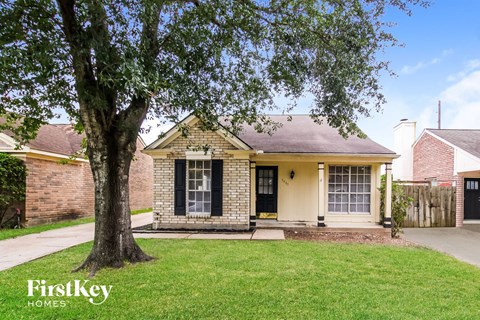 A house with a tree in front of it.