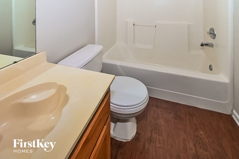 a bathroom with a toilet and a sink and a bath tub