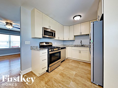 a kitchen with stainless steel appliances and white cabinets