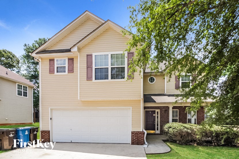 a yellow house with a white garage door
