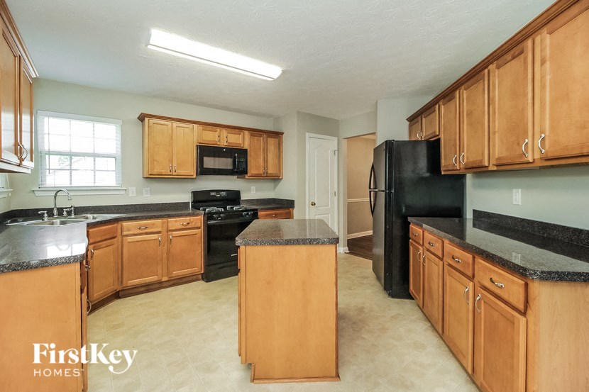 a kitchen with wooden cabinets and black appliances