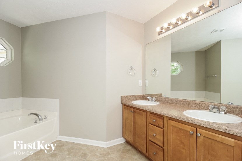 a bathroom with two sinks and a bath tub