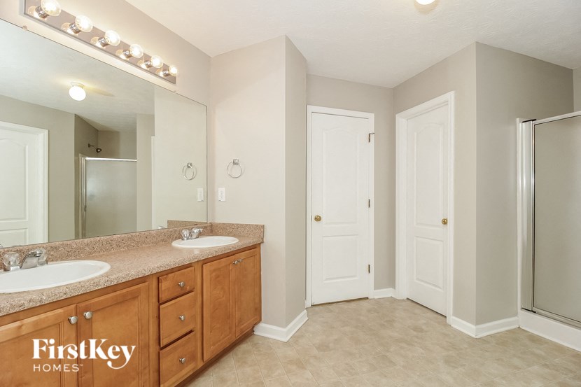 a bathroom with two sinks and a mirror