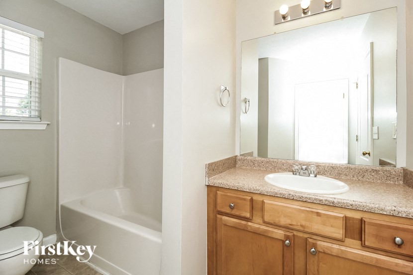a bathroom with a sink and a toilet and a shower