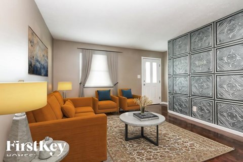 A living room with a brown sofa, a grey coffee table, and a glass block wall.