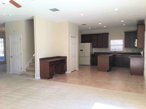 A kitchen area with brown cabinets and a countertop.