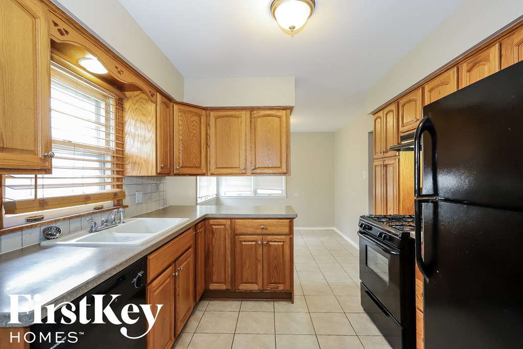a kitchen with black appliances and wooden cabinets