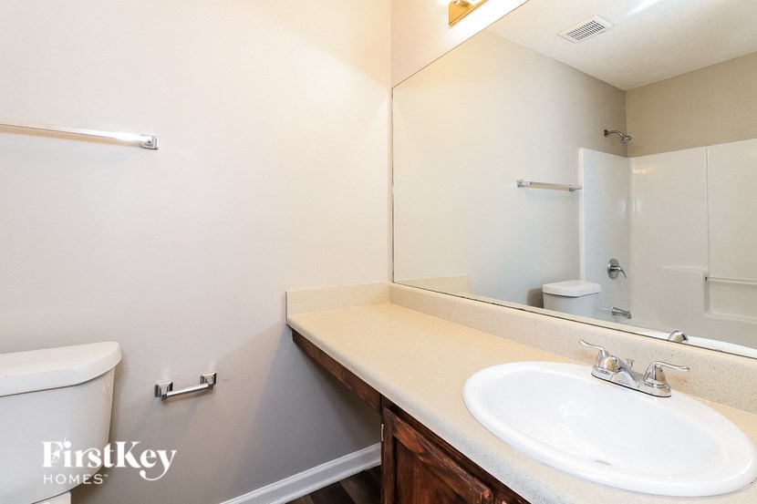a bathroom with a sink and a mirror and a toilet