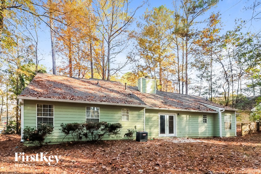 a green house in the middle of the woods