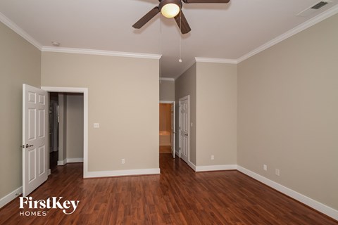 a living room with wood flooring and a ceiling fan