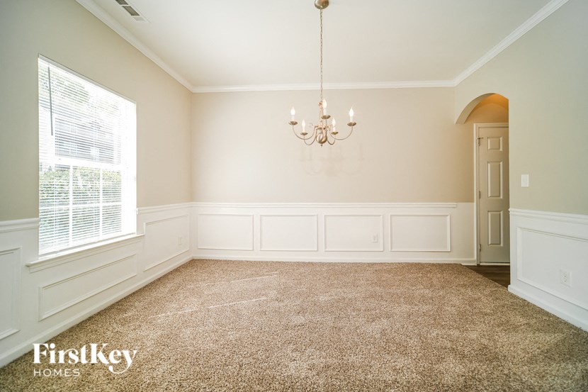 a dining room with a chandelier and a window
