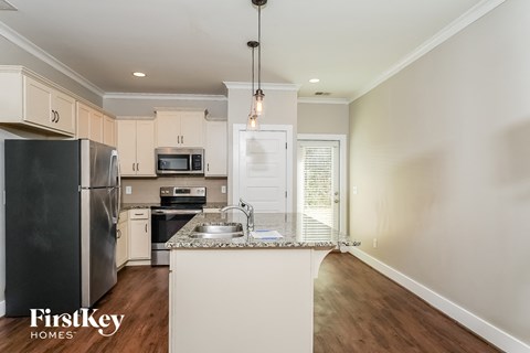a kitchen with white cabinets and stainless steel appliances