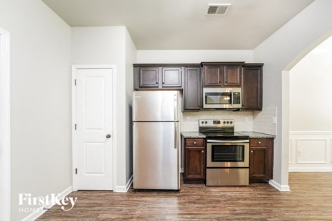 a kitchen with stainless steel appliances and brown cabinets