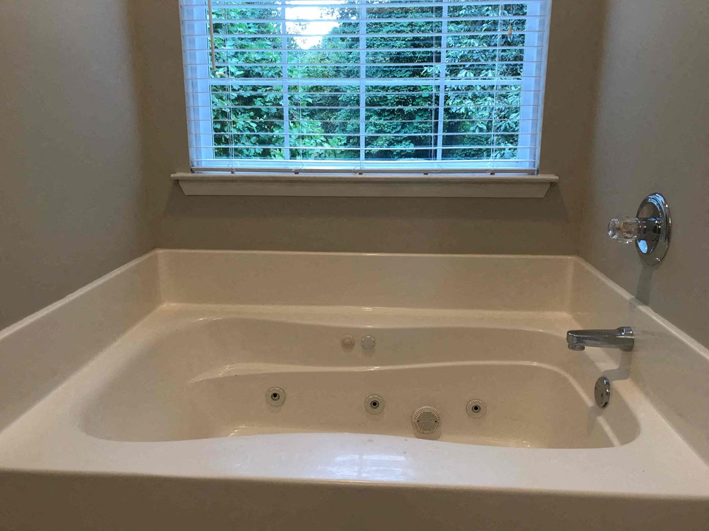 a jacuzzi tub in a bathroom with a window